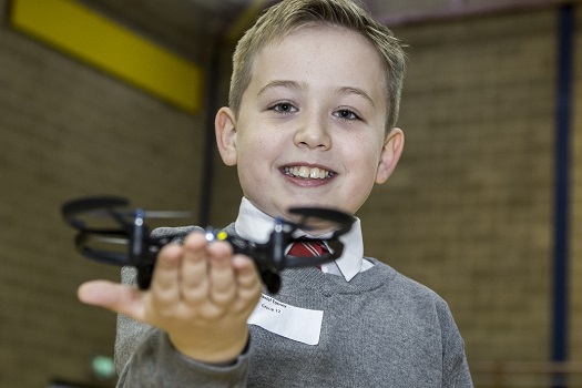 A child holding a drone