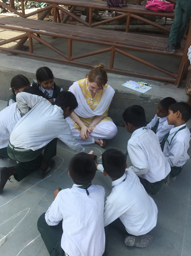 St Mary's student Claire McErlean with Sneha Doon Academy children.