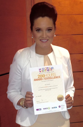 Nicol McArdle (Liberal Arts with Religious Studies) displaying her 200-hour award.