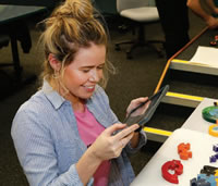 Student with an ipad photographing blocks