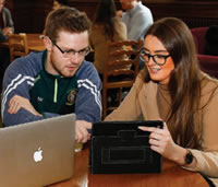 Two students looking at an ipad together