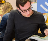 Student reading through a book